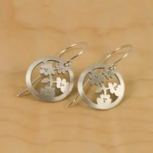 A pair of elegant Osaka Blossom Earrings adorned with delicate flowers.