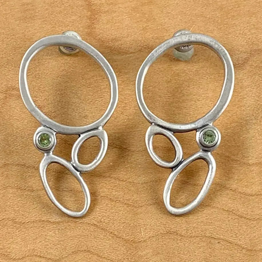 A pair of Sea Foam Earrings with peridot stones.