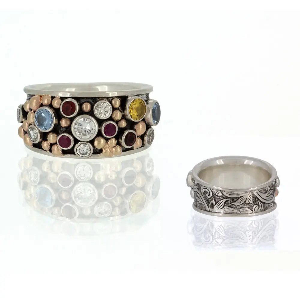A custom silver ring adorned with multi-colored stones.